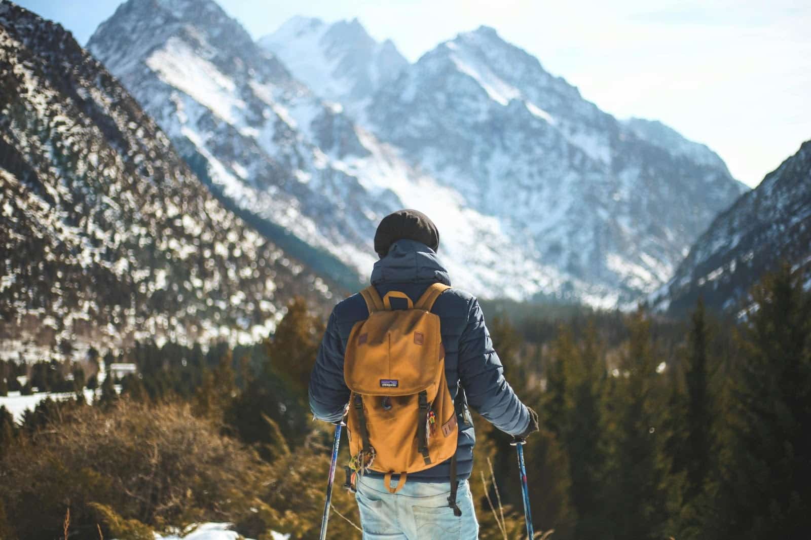 Man walking outdoors with a backpack, illustrating dopamine fasting through digital detox and time away from technology.