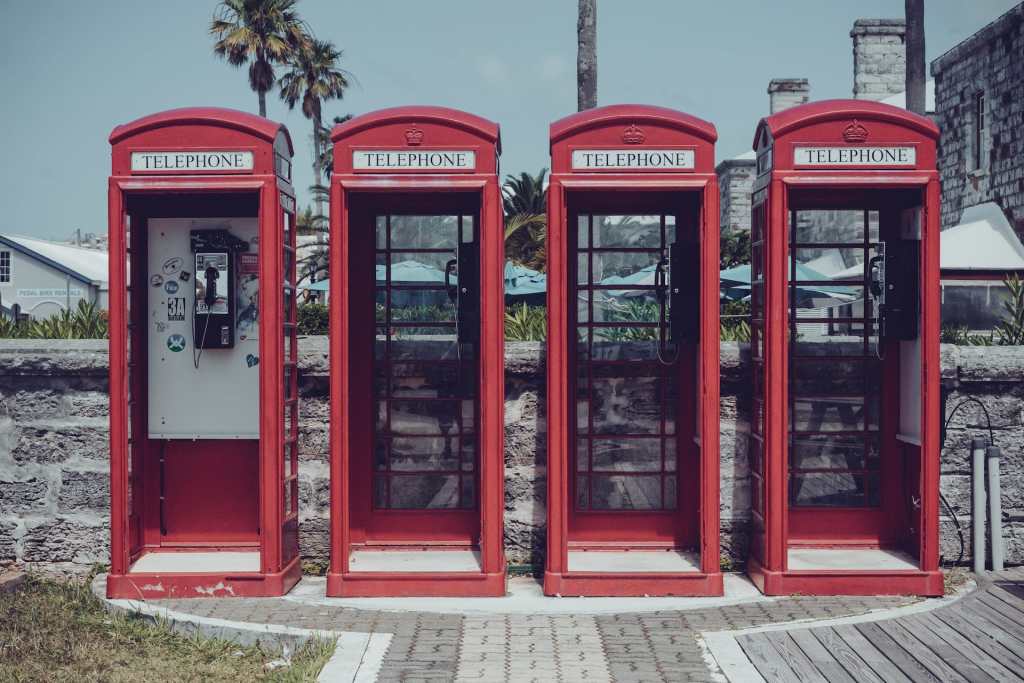 old fashioned red phone boxes in a line in Bermuda