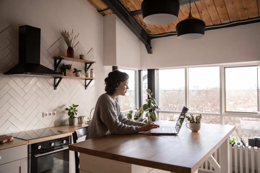 woman working from home in kitchen flexible schedule