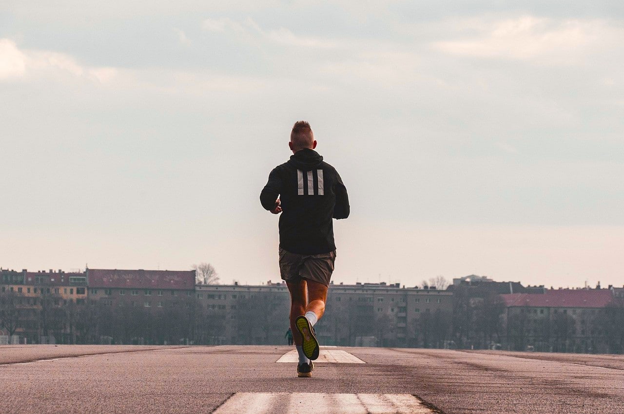 Runner starting his day with a jog, ready to face the world, reflecting Monday Motivation through movement and energy.