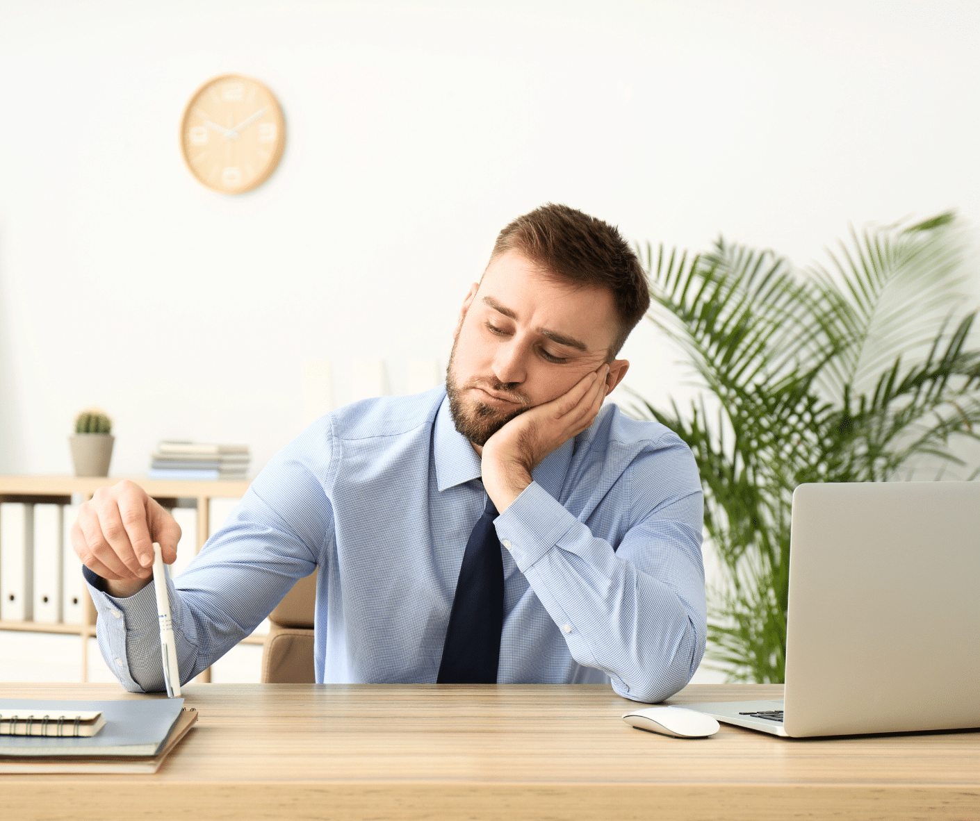 Man at work looking distracted and bored, showing signs of short attention span.